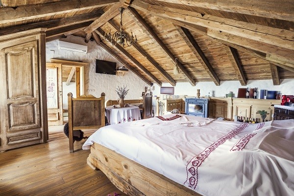 A rustic appeal can be achieved with the use of wooden floor, fireplace, and furniture.