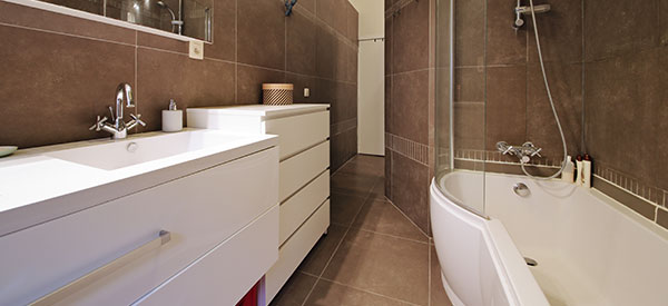 Small bathrooms can look bigger with designer tricks that are so practical.