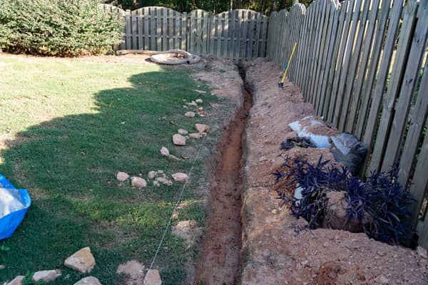 Installing a French drain.