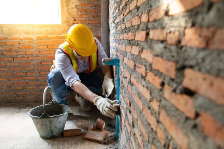 Bricklayer working on a wall installation.