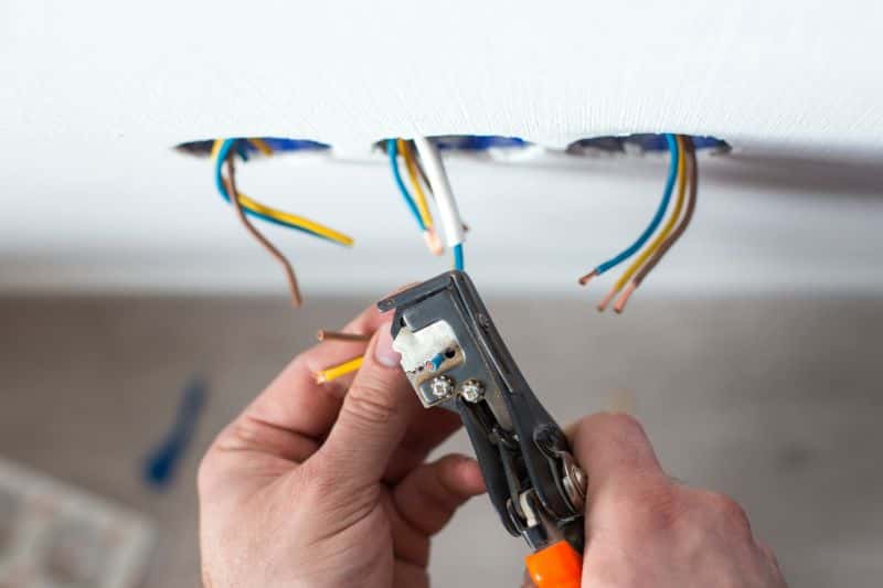 Electrician installing a new electrical outlet