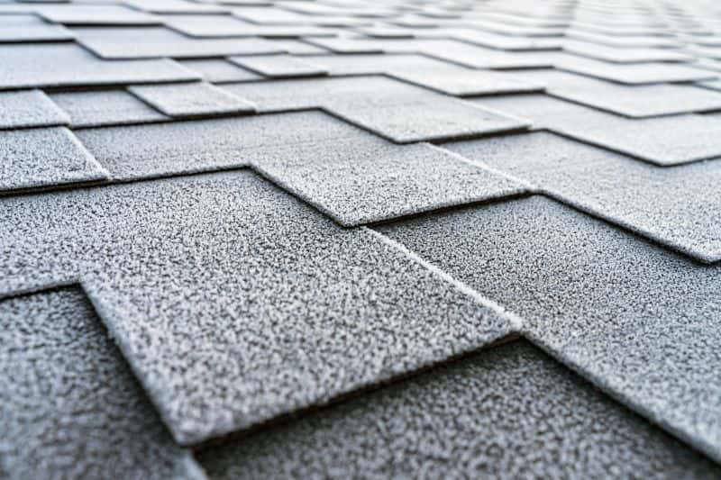 Frost-covered asphalt roof shingles