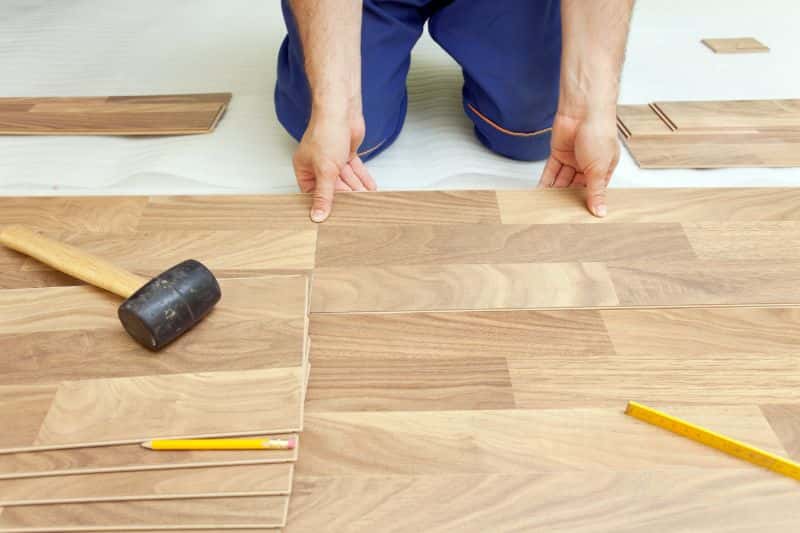 Professional installing wood laminate flooring