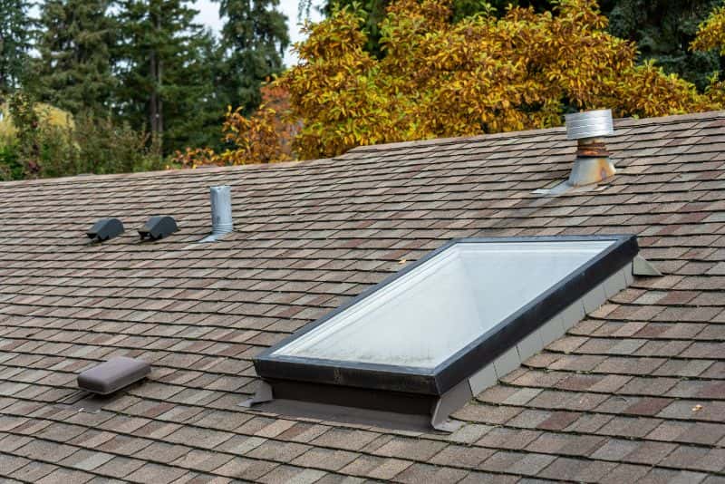 Top view of an asphalt shingle roof with skylight