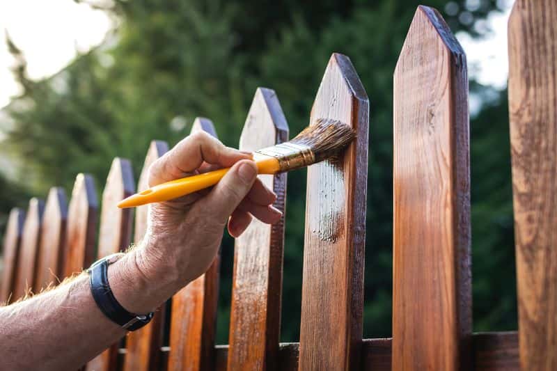 Painting a wooden picket fence