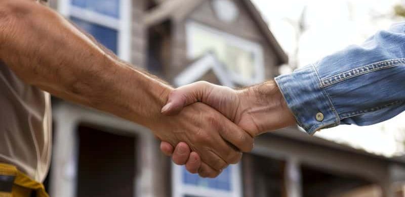 Homeowner shakes hands with general contractor for renovation